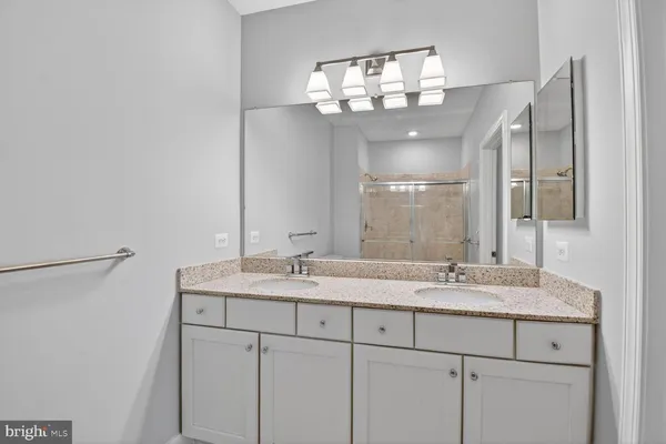 a bathroom with a glass shower door