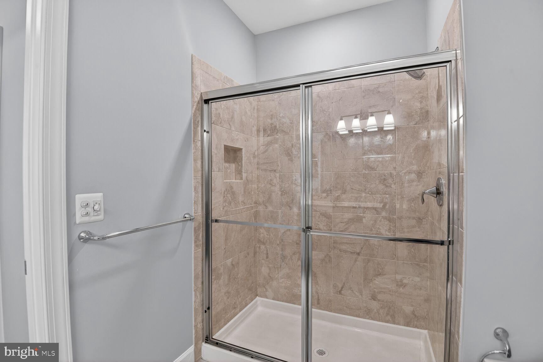 10530 Resort Road, Unit 210 Ellicott City, MD 21042 - Photo 18 of 35 a bathroom with a glass shower door