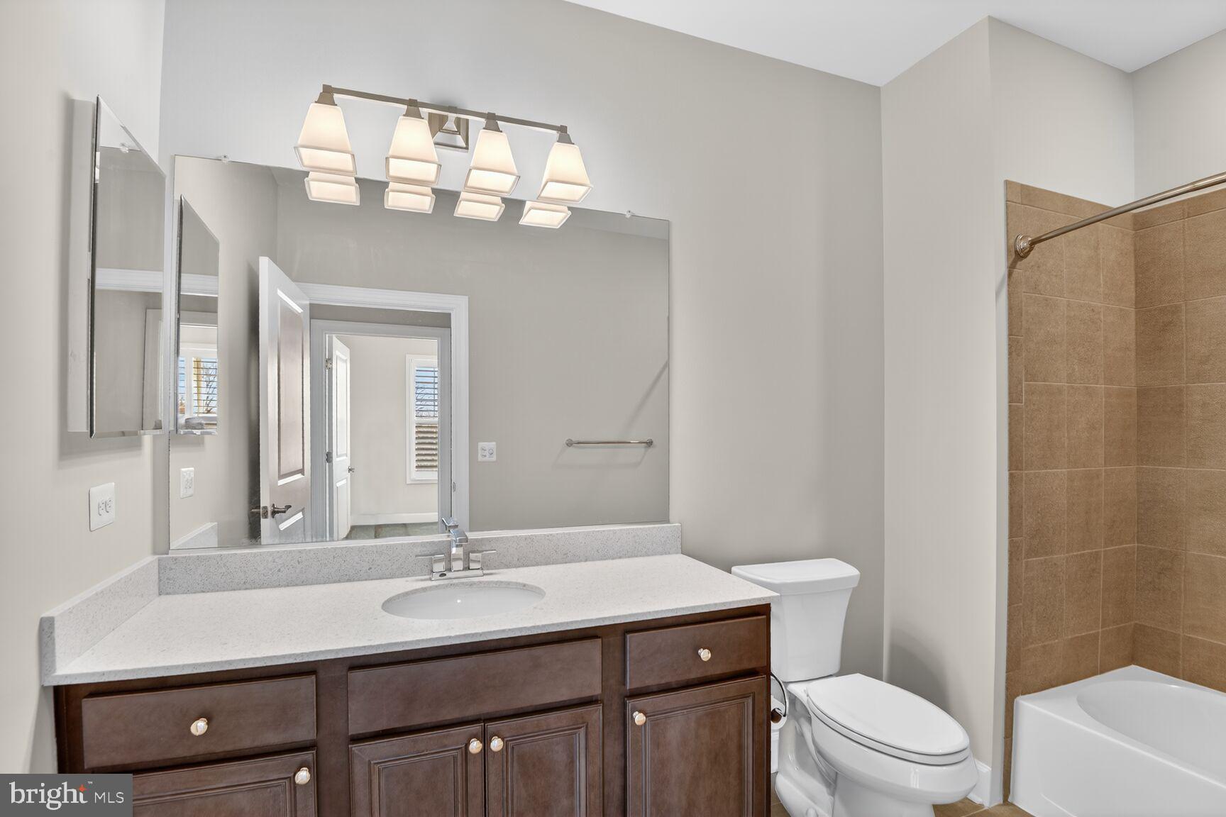 10530 Resort Road, Unit 210 Ellicott City, MD 21042 - Photo 22 of 35 a bathroom with a sink a toilet and a mirror