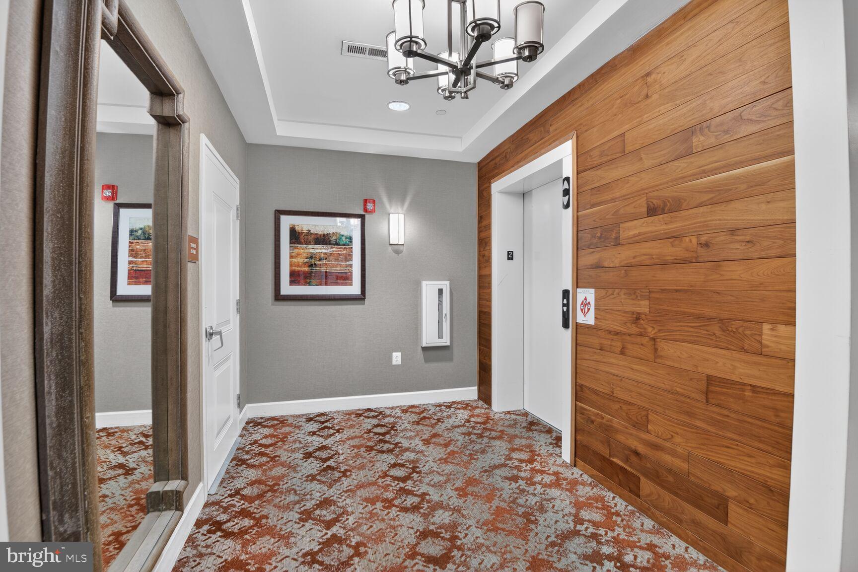 10530 Resort Road, Unit 210 Ellicott City, MD 21042 - Photo 26 of 35 a view of a hallway with front door and wooden floor