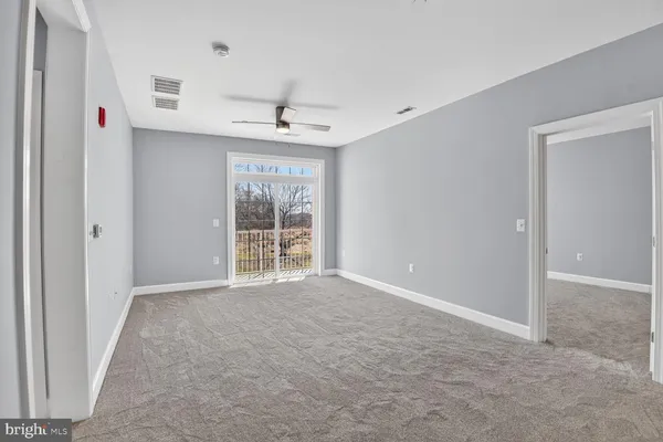 a bedroom with a bed a mirror and a window