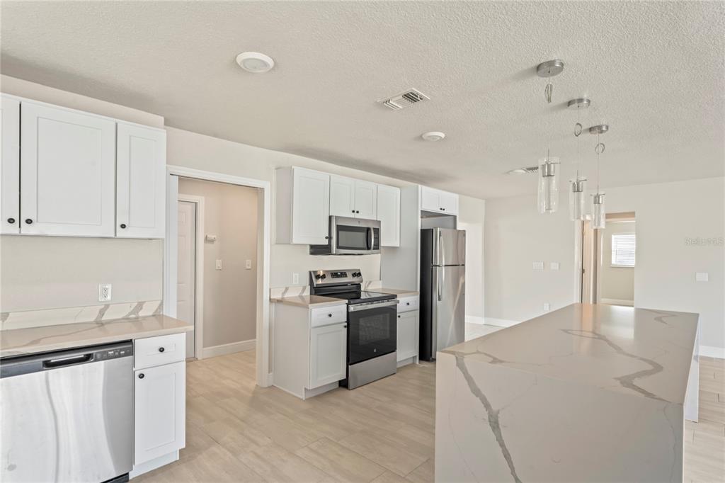 516 Crystal Drive Madeira Beach, FL 33708 - Photo 12 of 25 a kitchen with stainless steel appliances granite countertop a refrigerator and a sink