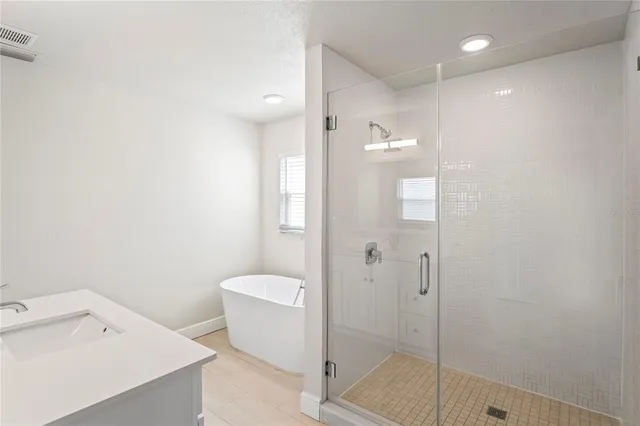 a bathroom with a shower and sink