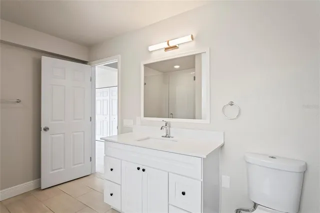 a bathroom with a sink vanity and a mirror