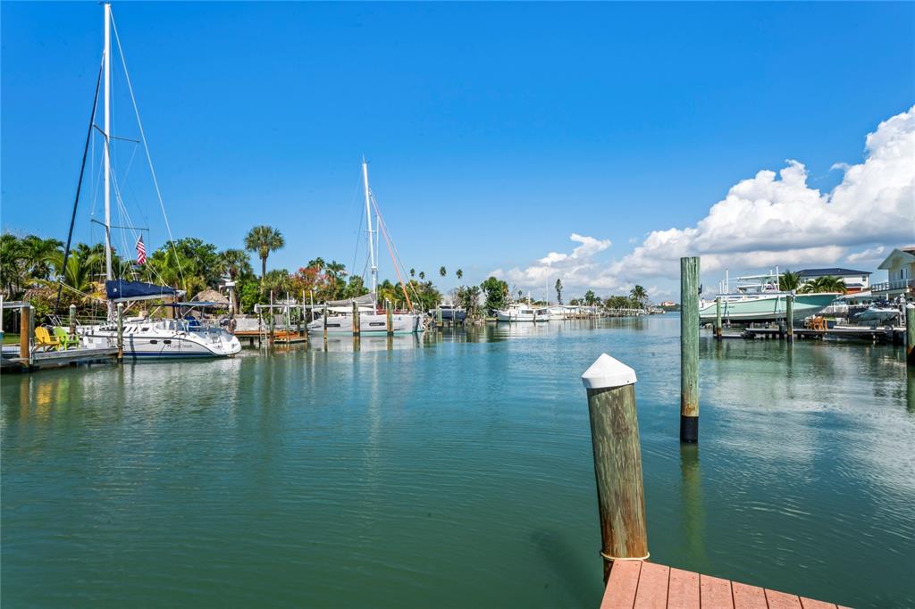516 Crystal Drive Madeira Beach, FL 33708 - Photo 2 of 25 a view of water with boats and trees in the background