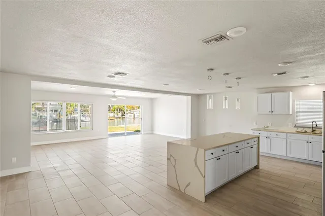 a large white kitchen with cabinets