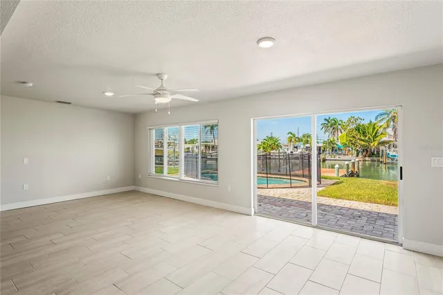 an empty room with windows and pool table