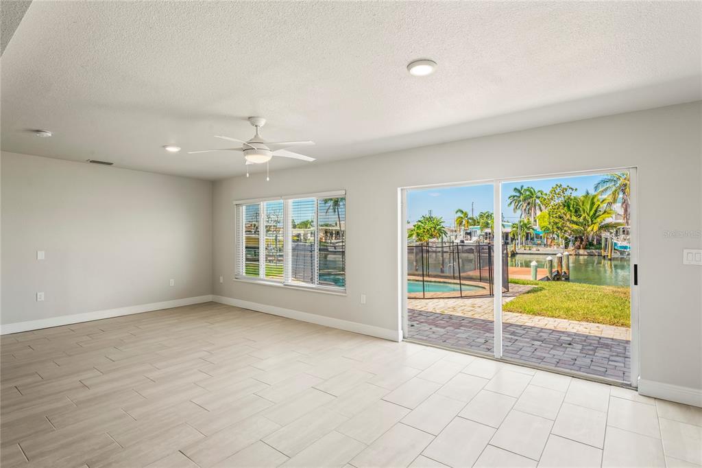 516 Crystal Drive Madeira Beach, FL 33708 - Photo 7 of 25 an empty room with windows and pool table