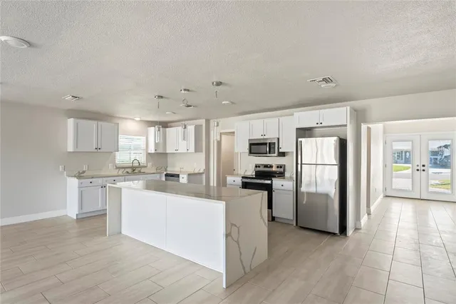 a kitchen with refrigerator and cabinets