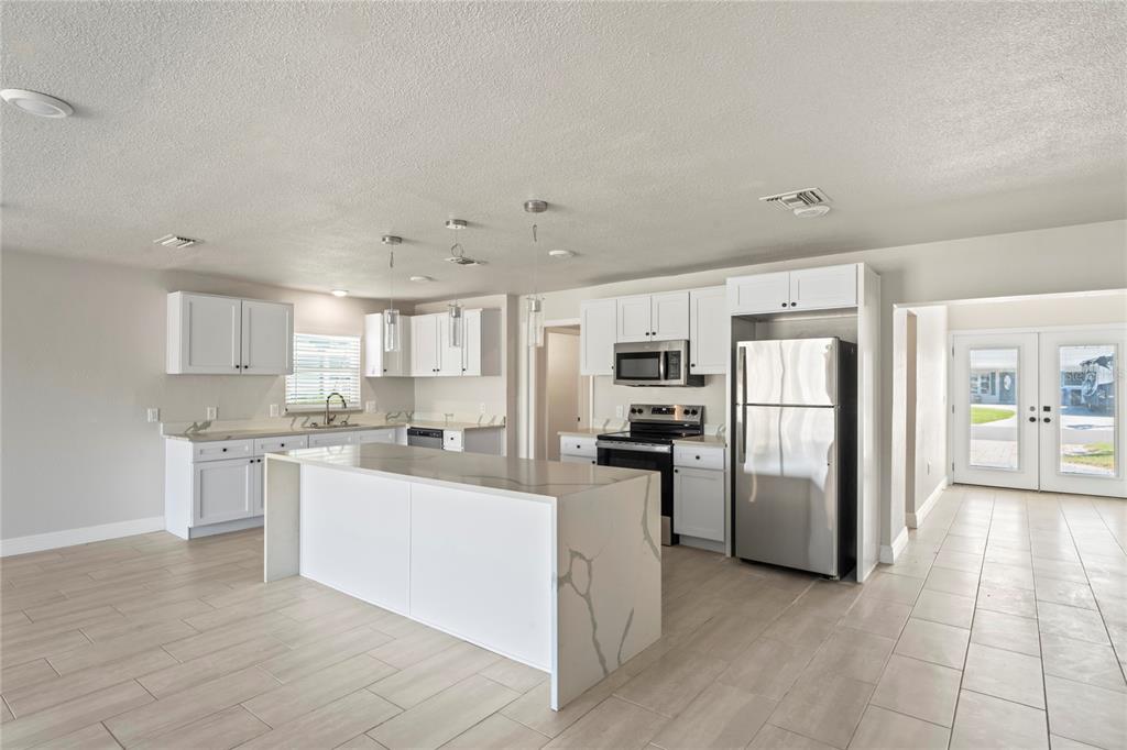 516 Crystal Drive Madeira Beach, FL 33708 - Photo 9 of 25 a kitchen with refrigerator and cabinets