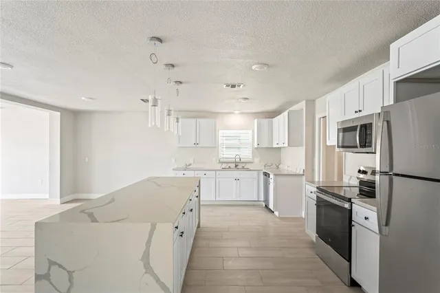a kitchen with white cabinets and white appliances