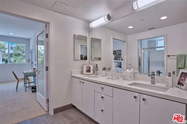 a spacious bathroom with a double vanity sink and a mirror
