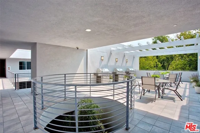 a dining room with furniture and a floor to ceiling window