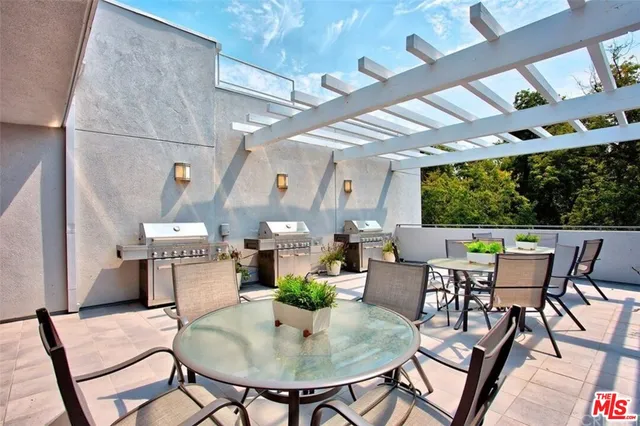 a dining room with furniture a rug and a floor to ceiling window