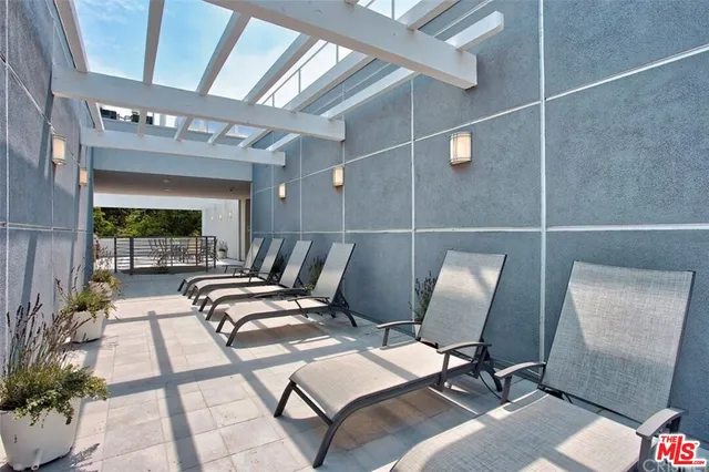 a outdoor space with lots of chairs and mirrors