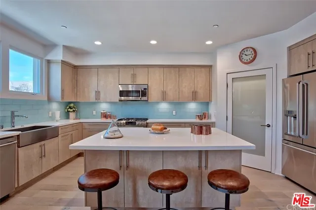 a kitchen with stainless steel appliances granite countertop a sink counter space and cabinets