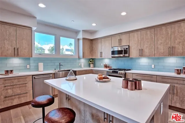 a kitchen with a sink a stove a microwave and cabinets