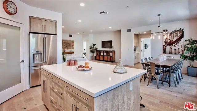 a open kitchen with stainless steel appliances granite countertop a stove and a refrigerator
