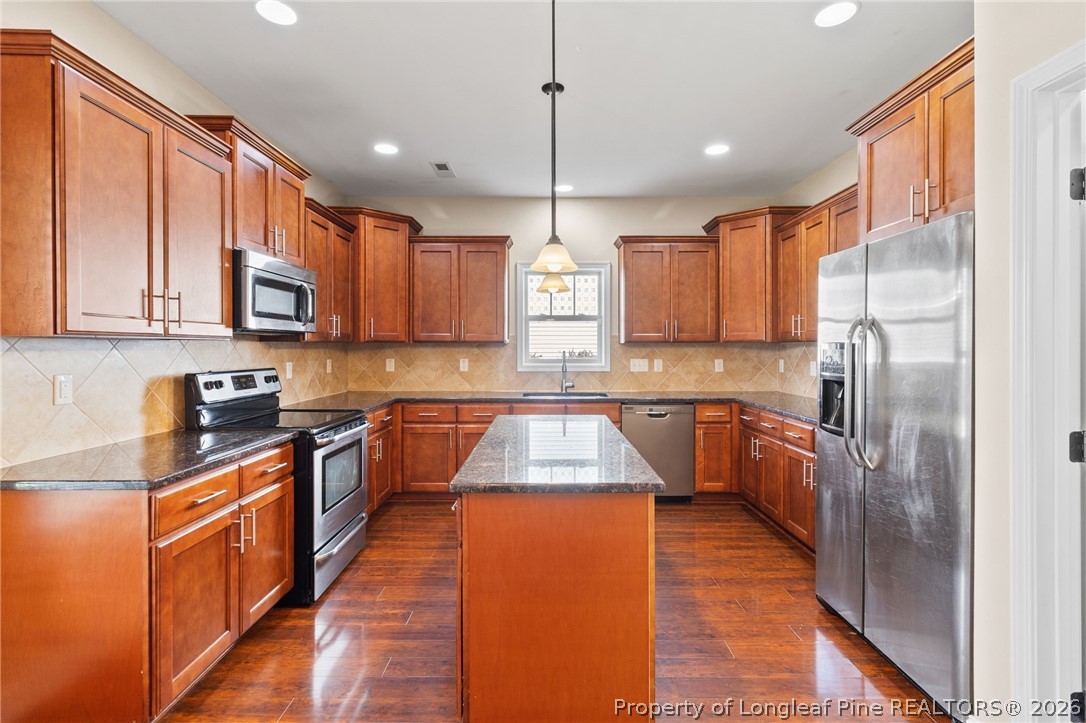 368 Exeter Drive Raeford, NC 28376 - Photo 11 of 49 a large kitchen with stainless steel appliances granite countertop a stove a sink dishwasher a refrigerator and a microwave oven with wooden floor