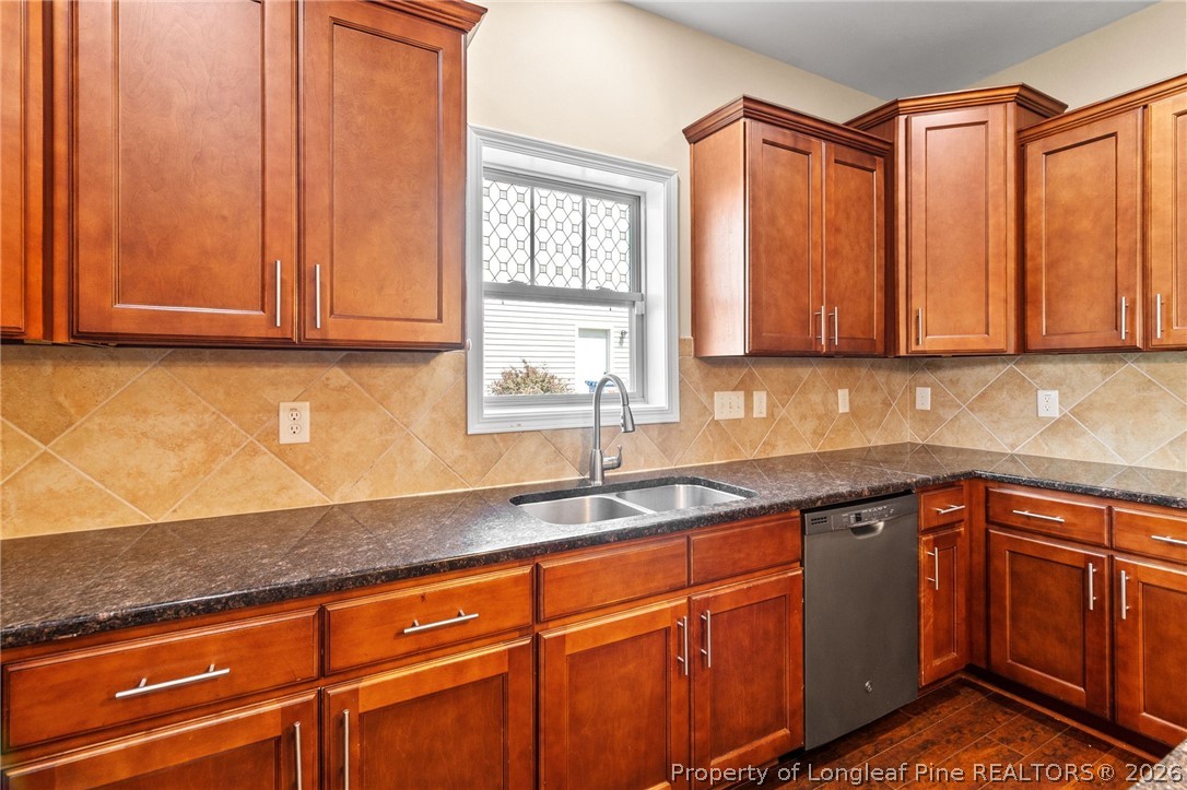 368 Exeter Drive Raeford, NC 28376 - Photo 13 of 49 a kitchen with stainless steel appliances granite countertop a sink and cabinets with wooden floor