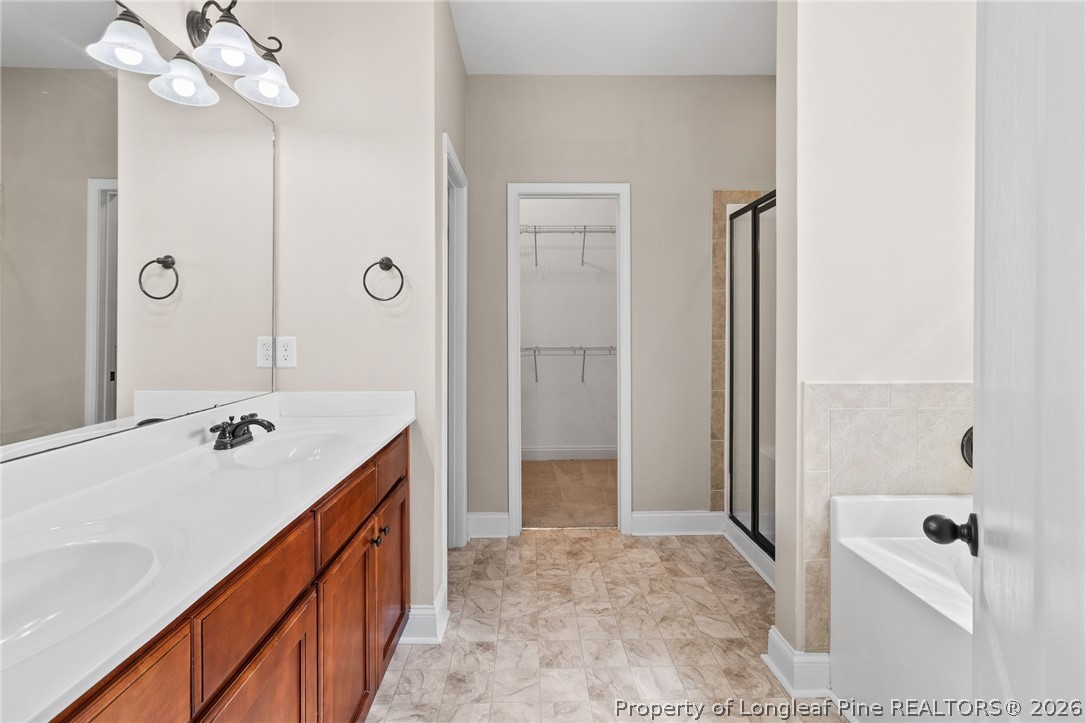 368 Exeter Drive Raeford, NC 28376 - Photo 21 of 49 a bathroom with a tub sink and mirror