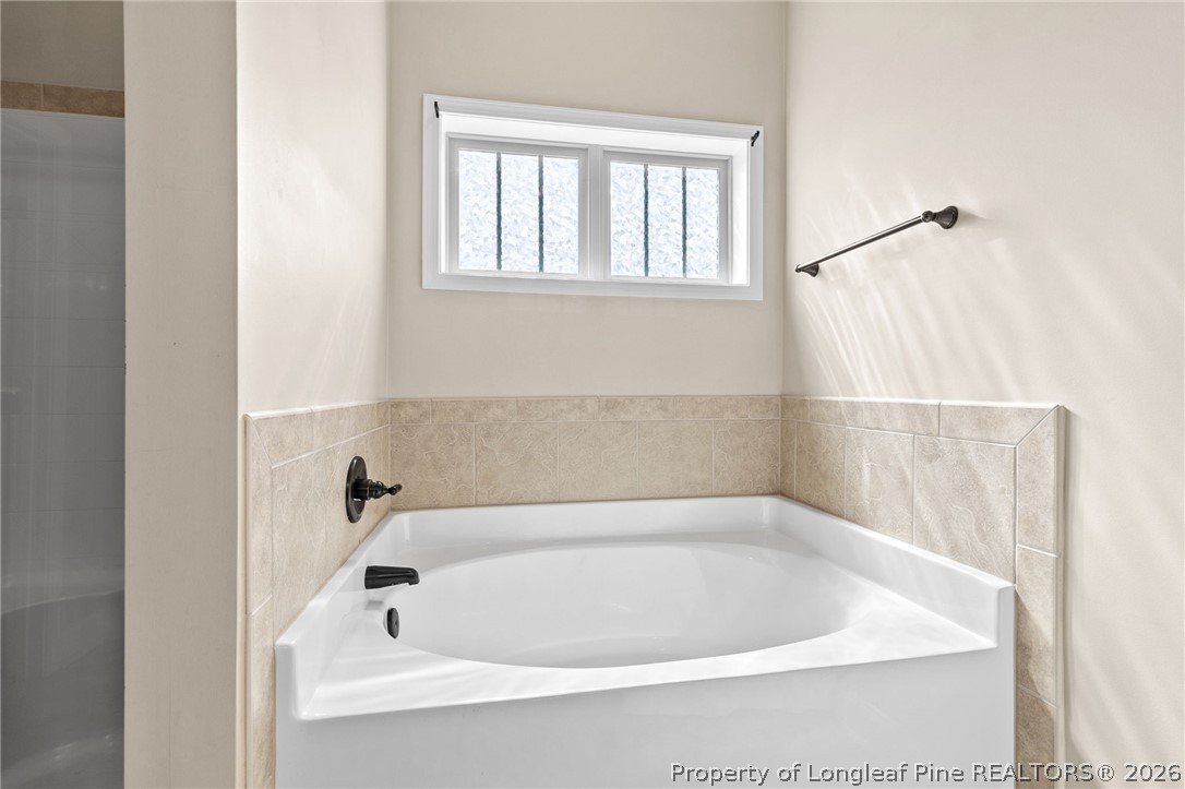 368 Exeter Drive Raeford, NC 28376 - Photo 24 of 49 a white bath tub sitting next to a window