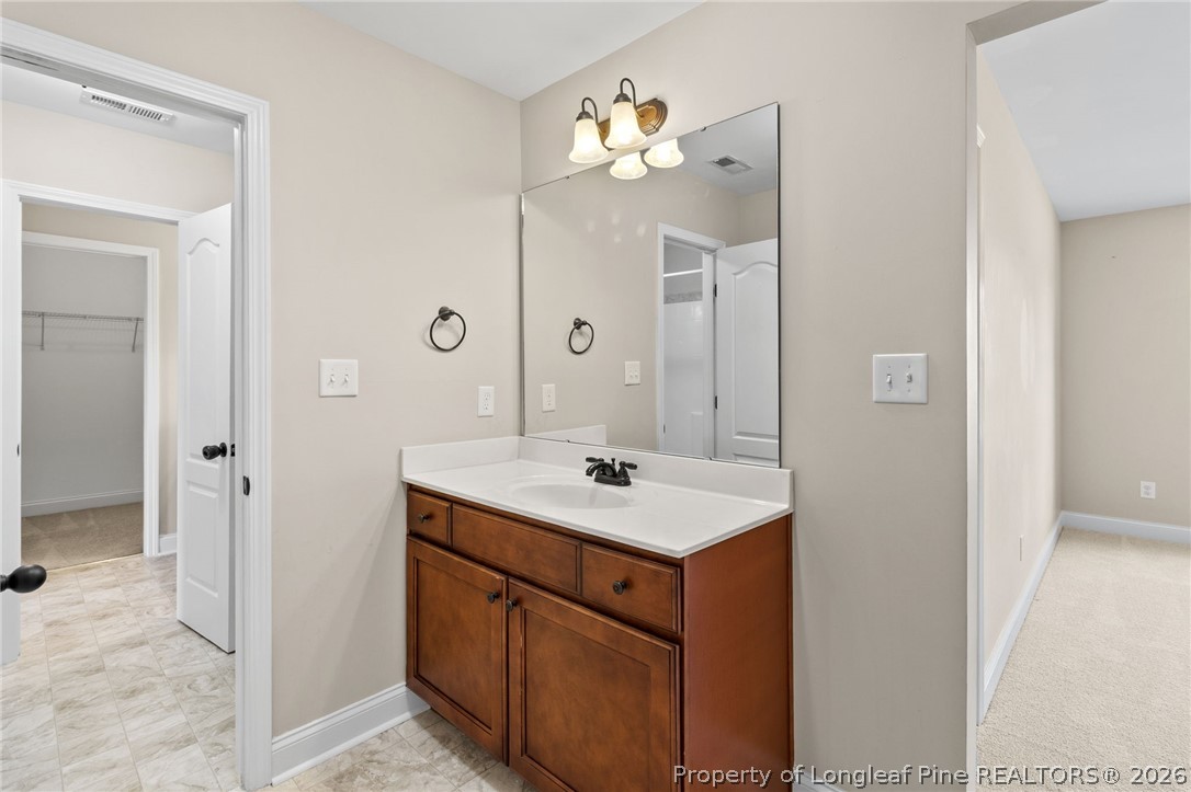 368 Exeter Drive Raeford, NC 28376 - Photo 35 of 49 a bathroom with a sink a mirror and a shower