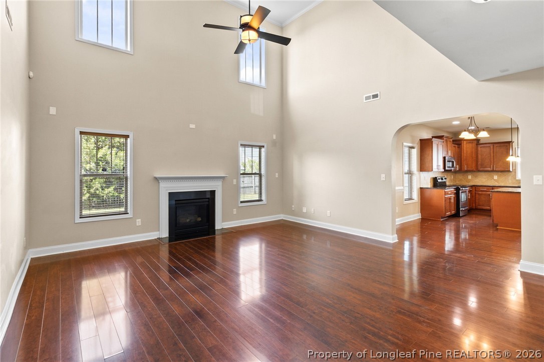 368 Exeter Drive Raeford, NC 28376 - Photo 8 of 49 a view of a livingroom with wooden floor and a kitchen space