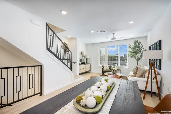 a living room with furniture fireplace and a large window