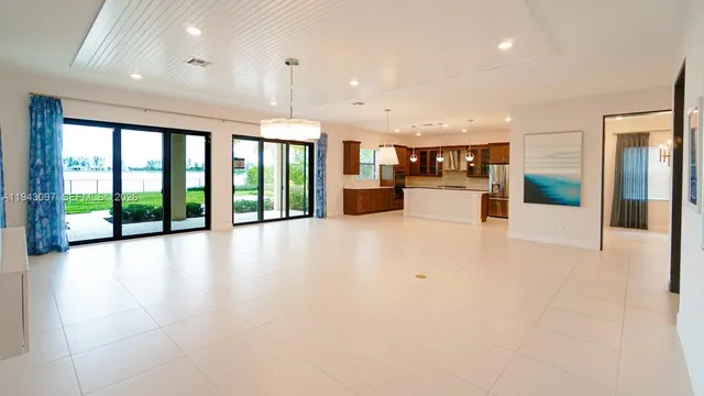 a living room with fireplace furniture and a potted plant
