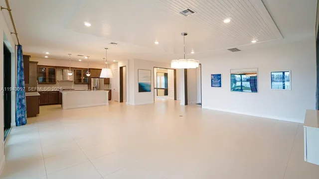 a view of an empty room with a chandelier