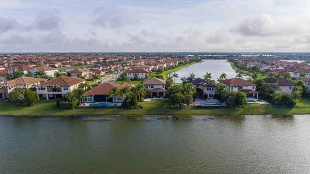 a view of a hallway with wooden floor and entryway