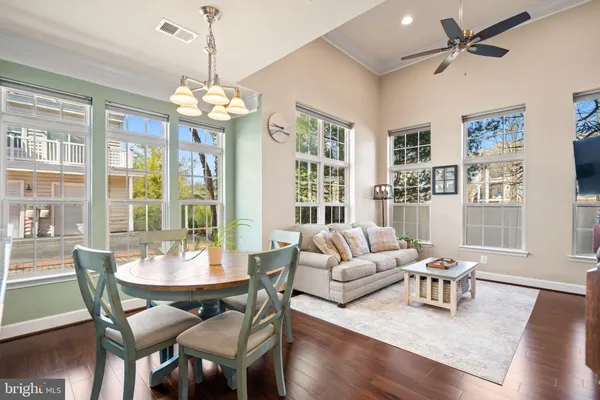 a view of a dining room with furniture wooden floor and chandelier