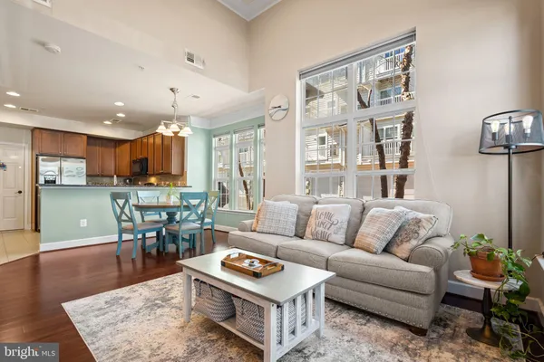 a living room with furniture kitchen view and a table