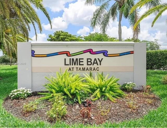 9401 Lime Bay Boulevard, Unit 114 Tamarac, FL 33321 - Photo 1 of 16 a sign that is on the side of the grass