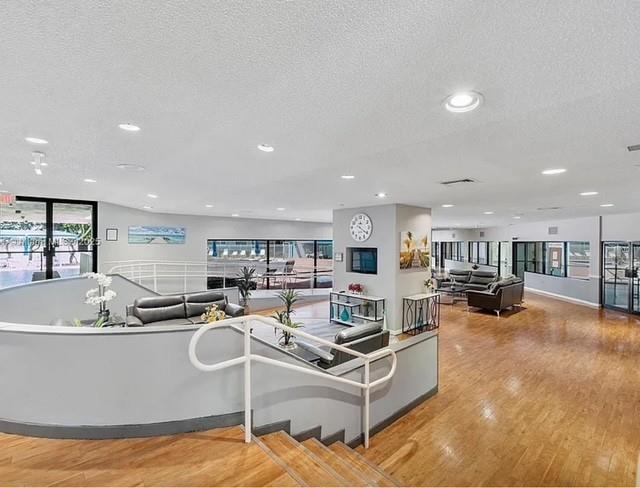 9401 Lime Bay Boulevard, Unit 114 Tamarac, FL 33321 - Photo 15 of 16 a living room with furniture and a flat screen tv