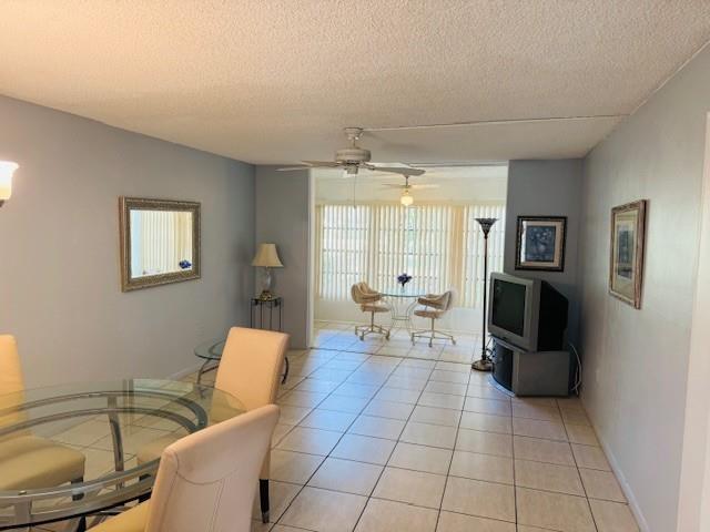 9401 Lime Bay Boulevard, Unit 114 Tamarac, FL 33321 - Photo 2 of 16 a living room with furniture and a flat screen tv