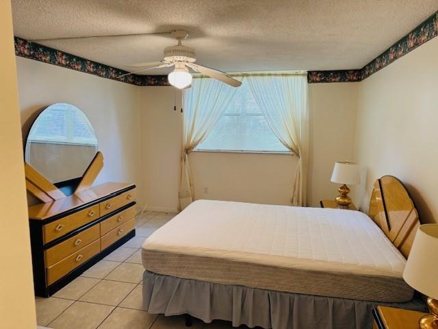 9401 Lime Bay Boulevard, Unit 114 Tamarac, FL 33321 - Photo 4 of 16 a bedroom with a bed and a dresser