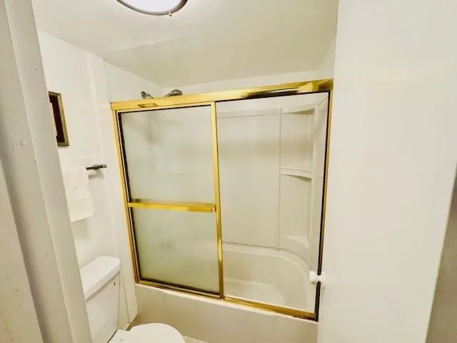 a bathroom with a glass shower door