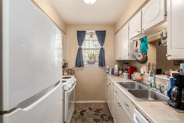 a room with a window a sink and a refrigerator
