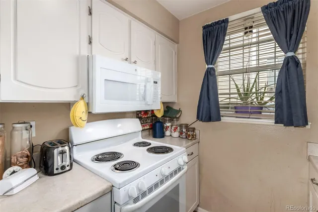 a kitchen with a stove a sink and a microwave