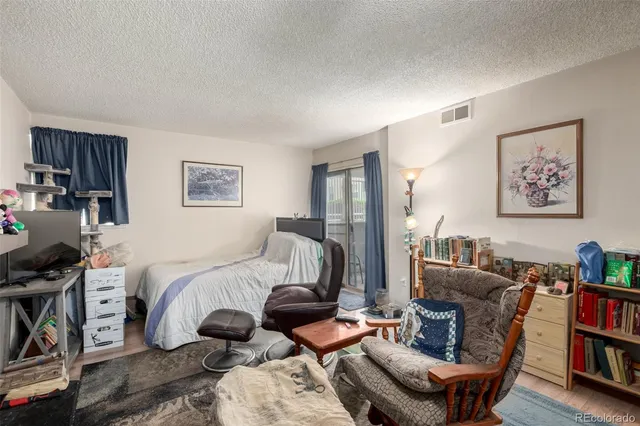 a bedroom with furniture and a book shelf