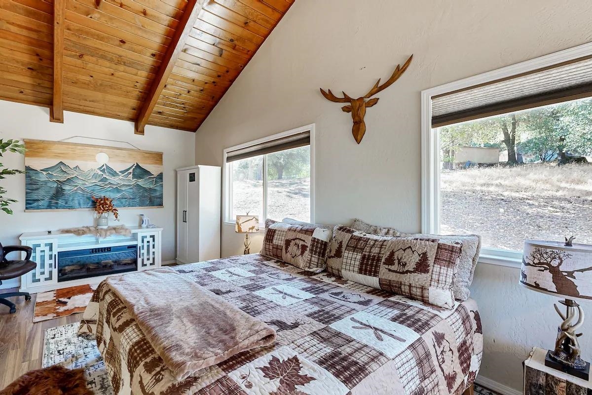 19385 Ferretti Road Groveland, CA 95321 - Photo 11 of 47 Bedroom with a wood ceiling with exposed beams, multiple windows, high vaulted ceiling, and wood finished floors
