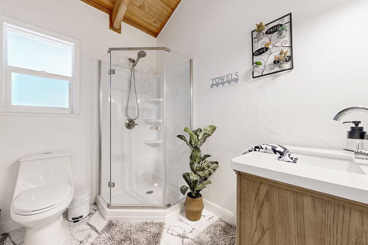 19385 Ferretti Road Groveland, CA 95321 - Photo 17 of 47 Bathroom featuring vanity, wood ceiling, a stall shower, and marble look tile flooring