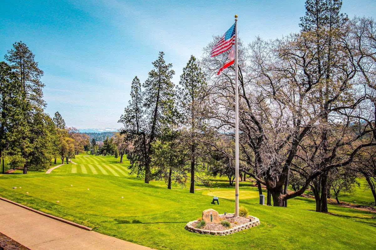 19385 Ferretti Road Groveland, CA 95321 - Photo 39 of 47 Surrounding community with a lawn, view of wooded area, and golf course view