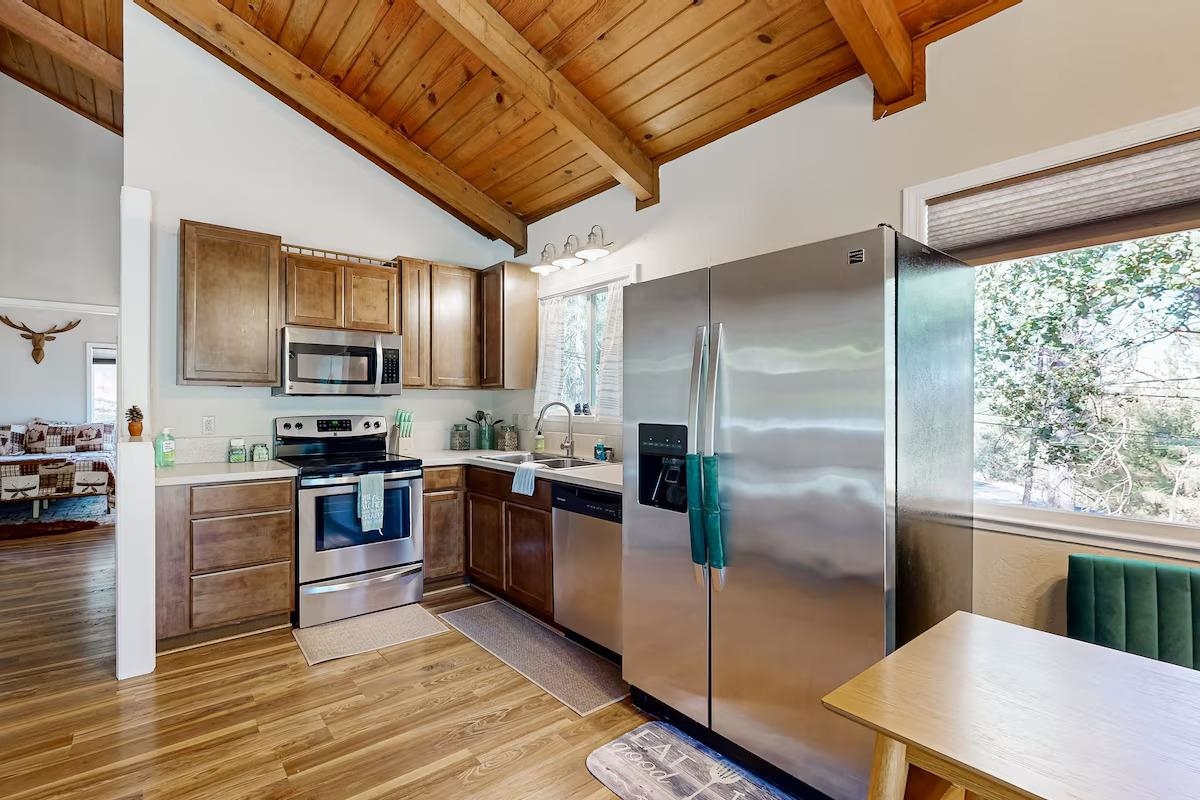 19385 Ferretti Road Groveland, CA 95321 - Photo 7 of 47 Kitchen with stainless steel appliances, light countertops, wooden ceiling, and light wood-type flooring