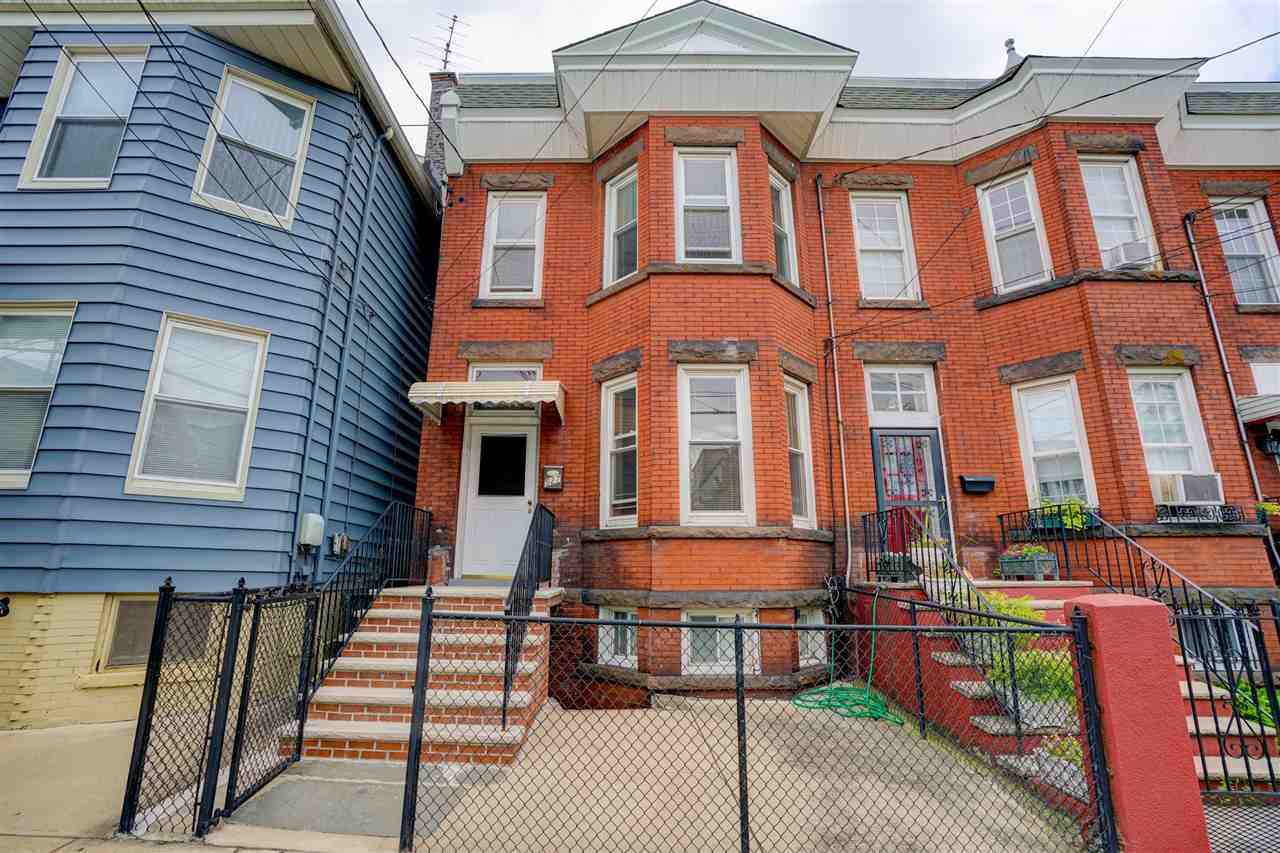 527 North 3rd Street East Newark, NJ 07029 - Photo 1 of 25 a front view of a residential apartment building with a yard