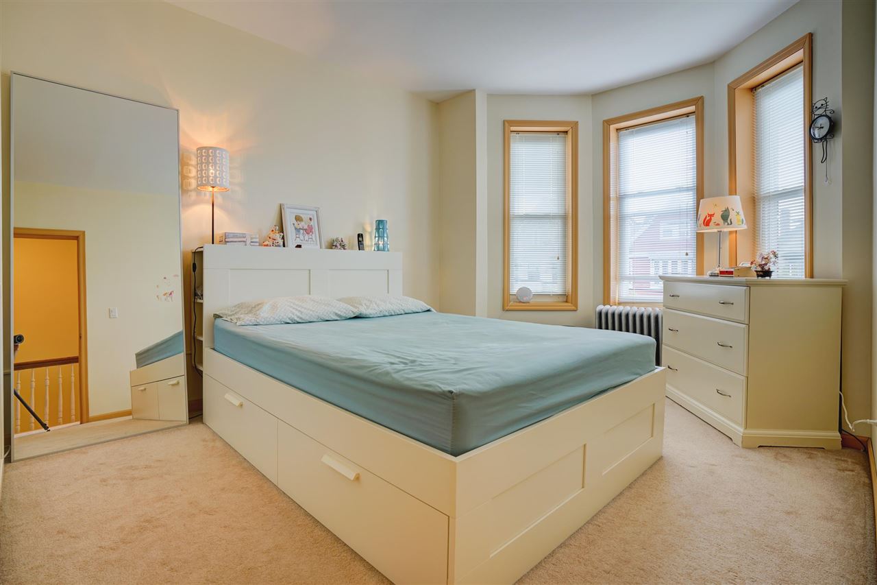 527 North 3rd Street East Newark, NJ 07029 - Photo 14 of 25 a bedroom with a bed and a cabinets
