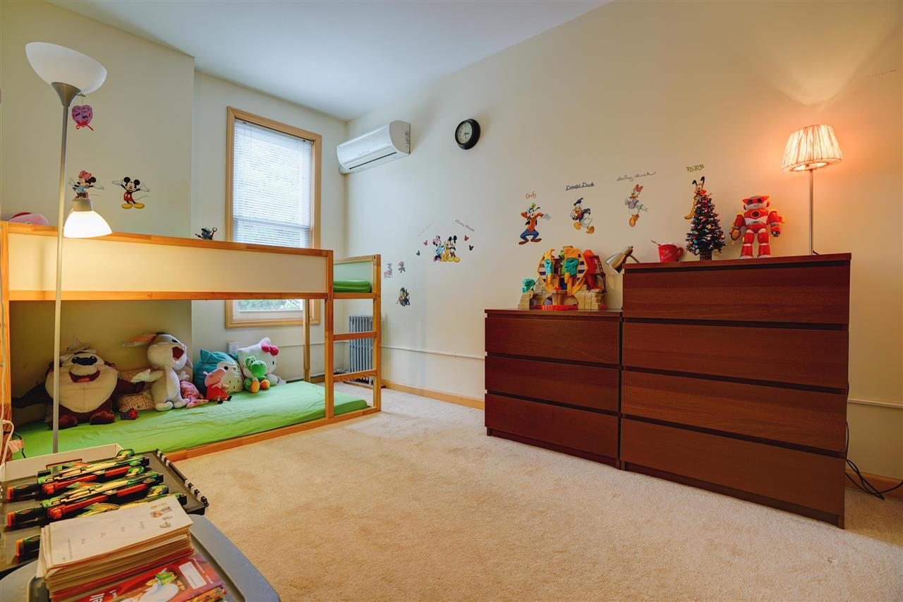 527 North 3rd Street East Newark, NJ 07029 - Photo 16 of 25 a bed room with a bed and a dresser in it