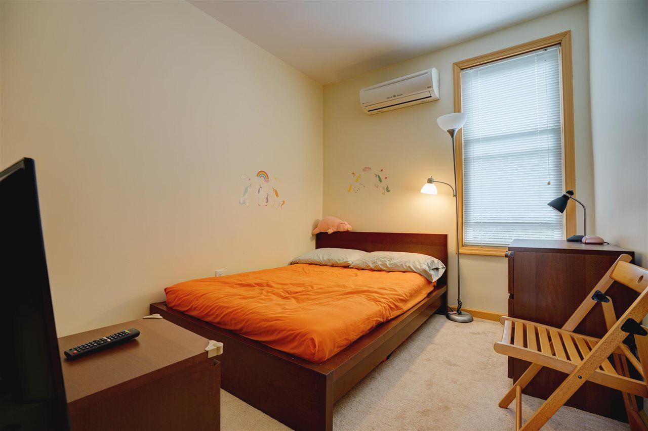 527 North 3rd Street East Newark, NJ 07029 - Photo 17 of 25 a bedroom with a bed and a window